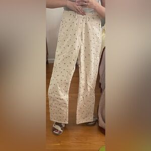 Cream jeans with black floral pattern